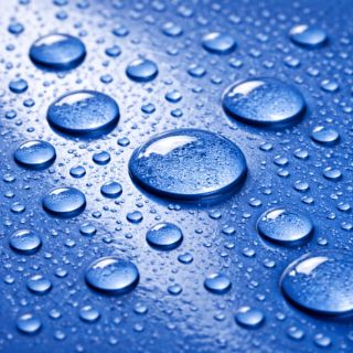 Gouttes d'eau perlant sur une peinture filmogène parfaite
